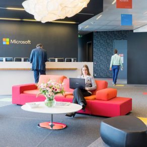 A photo of workers in an office at microsoft with color furniture