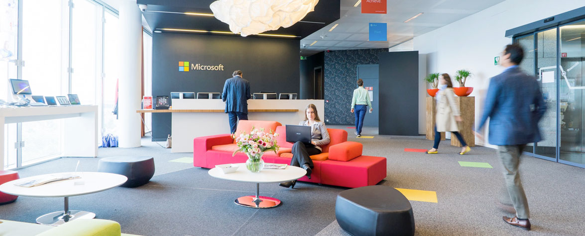 A photo of workers in an office at microsoft with color furniture